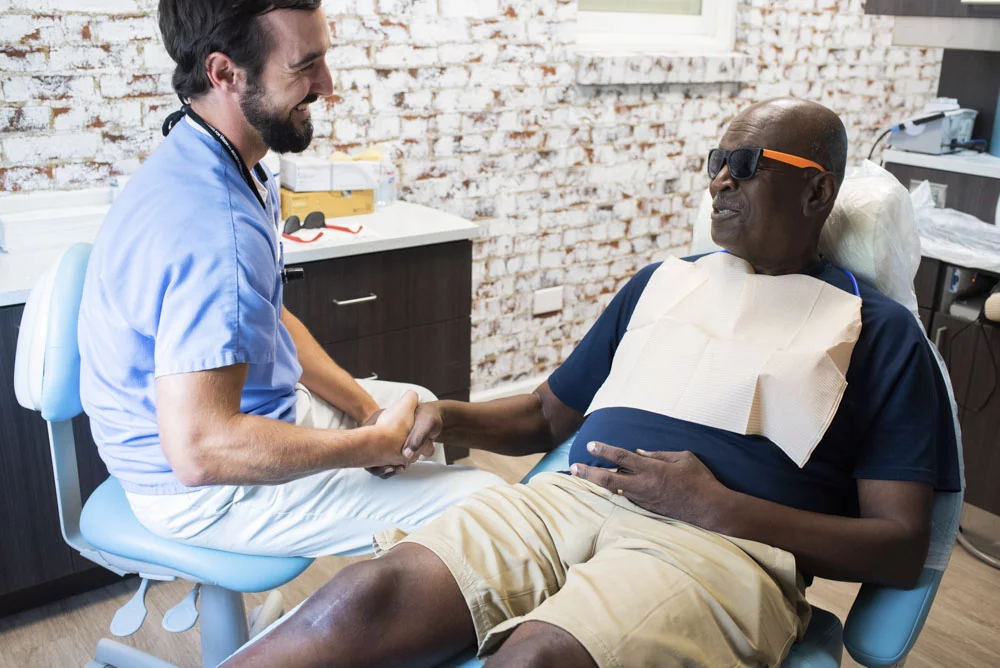 Dr. Jon Byrd of High Point Dental Partners with patient in dental exam room